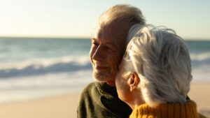 Old couple relaxing at the beach